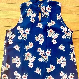 Sleeveless blue floral print top. Size medium.